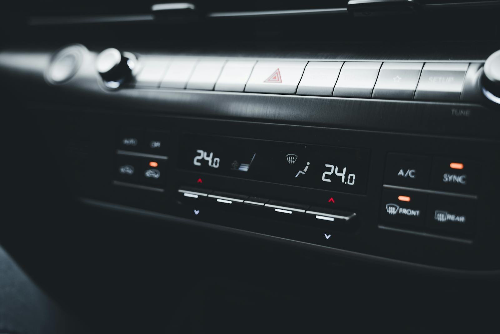 Close-up shot of a car's climate control system displaying temperature settings.
